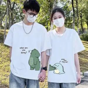 Zwei Personen in weißen T-Shirts mit grünem und blauem Dinosaurier-Aufdruck am Saum