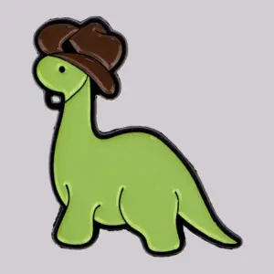 Grüne Dinosaurier-Anstecknadel mit braunem Cowboyhut
