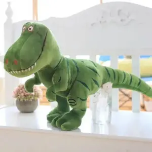 Grünes Stoffdinosaurier-Kuscheltier T-Rex mit gestreiftem Schwanz auf einem weißen Regal
